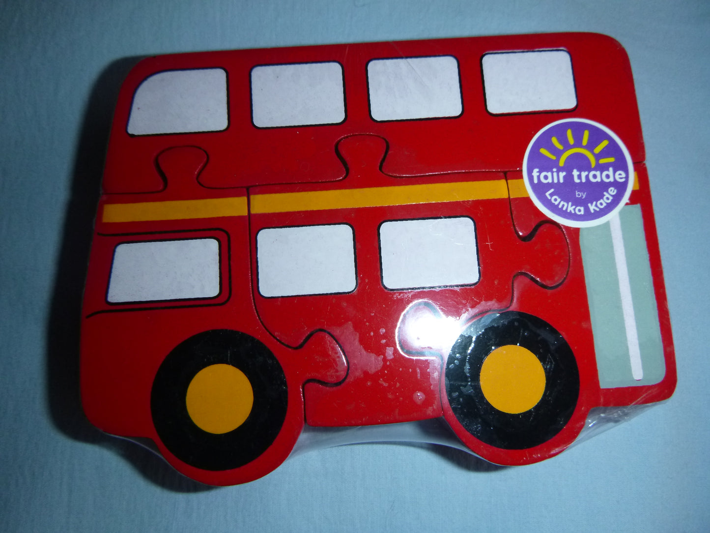 Lok, Bus und Elefant als Holz-Puzzle mit Fair Trade Siegel